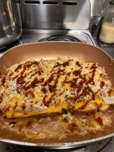 A picture of a fan fried sandwich with a cannabis infused Sriracha sauce